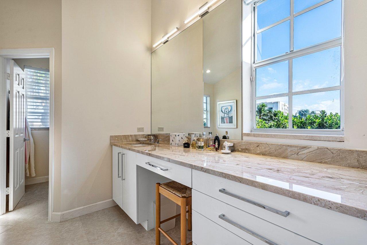 169 Apollo Circle Jupiter, FL 33477 - Photo 39 of 54 a bathroom with a granite countertop sink and a mirror
