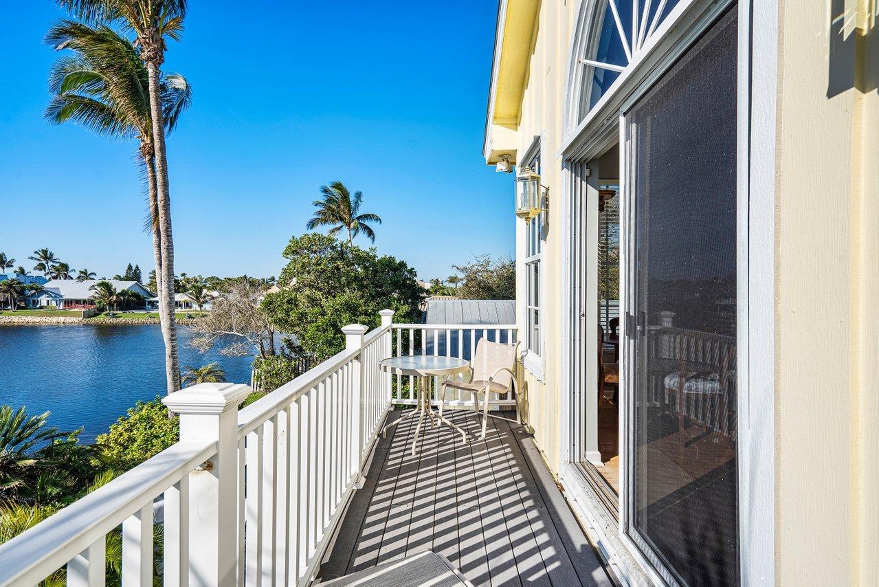 169 Apollo Circle Jupiter, FL 33477 - Photo 44 of 54 a view of a balcony with wooden floor next to a lake