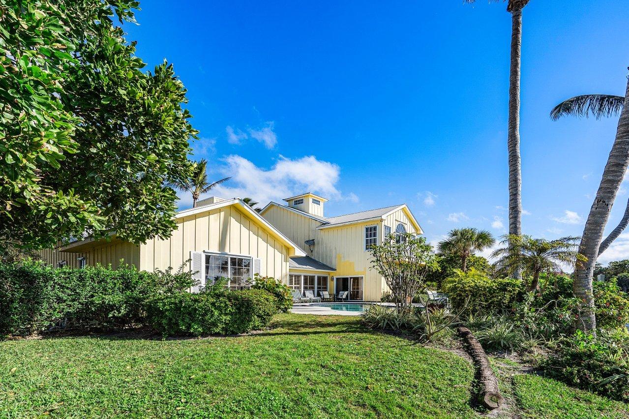 169 Apollo Circle Jupiter, FL 33477 - Photo 48 of 54 a front view of a house with garden