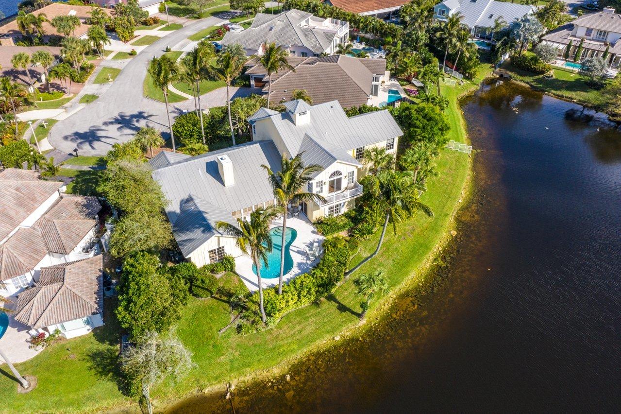 169 Apollo Circle Jupiter, FL 33477 - Photo 52 of 54 an aerial view of a house with a yard swimming pool patio and lake view