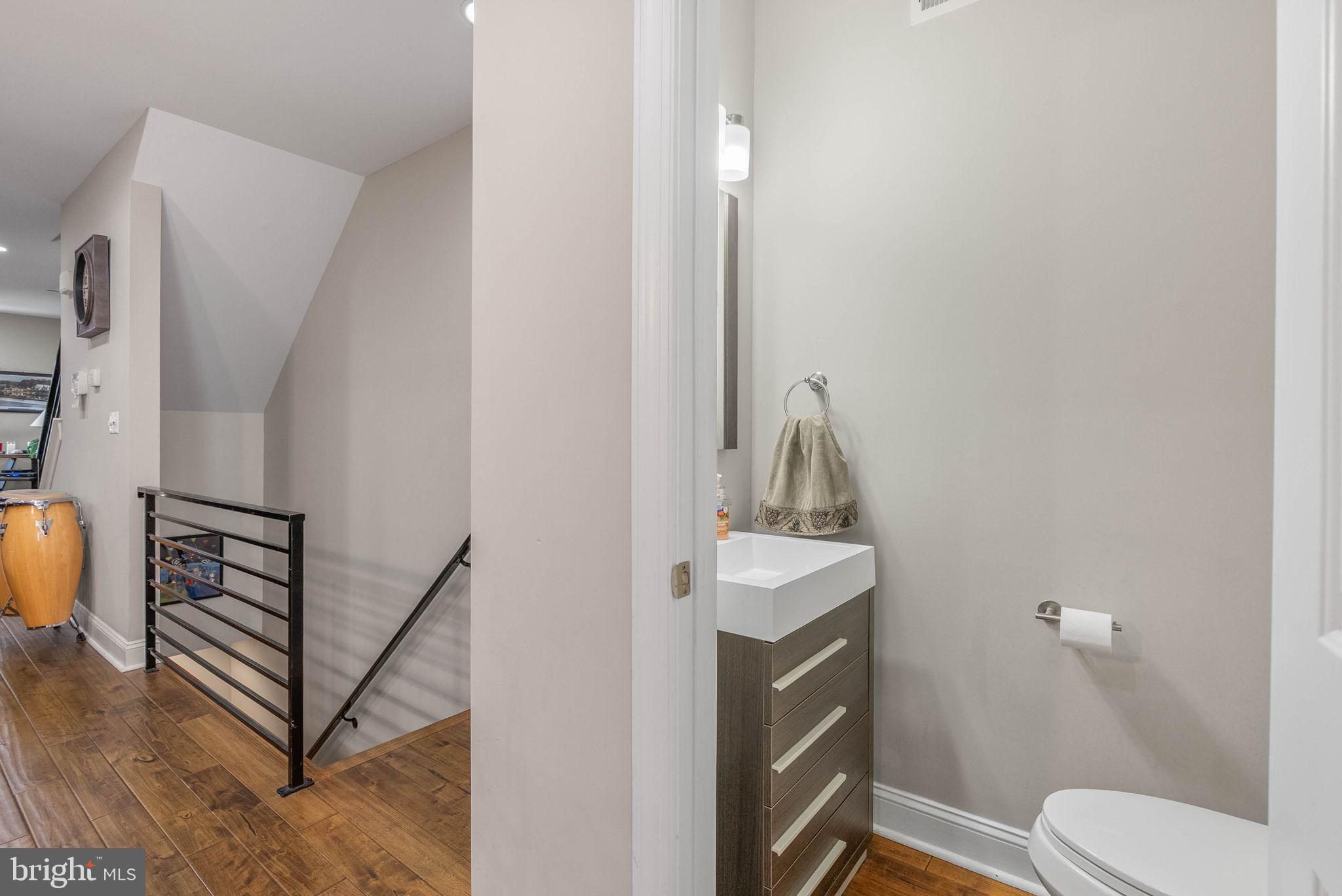 1423 South Howard Street Philadelphia, PA 19147 - Photo 16 of 40 a bathroom with a toilet a sink and mirror