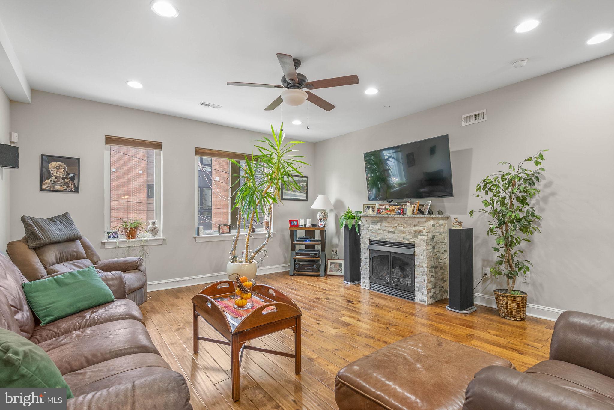 1423 South Howard Street Philadelphia, PA 19147 - Photo 20 of 40 a living room with furniture a fireplace and a flat screen tv