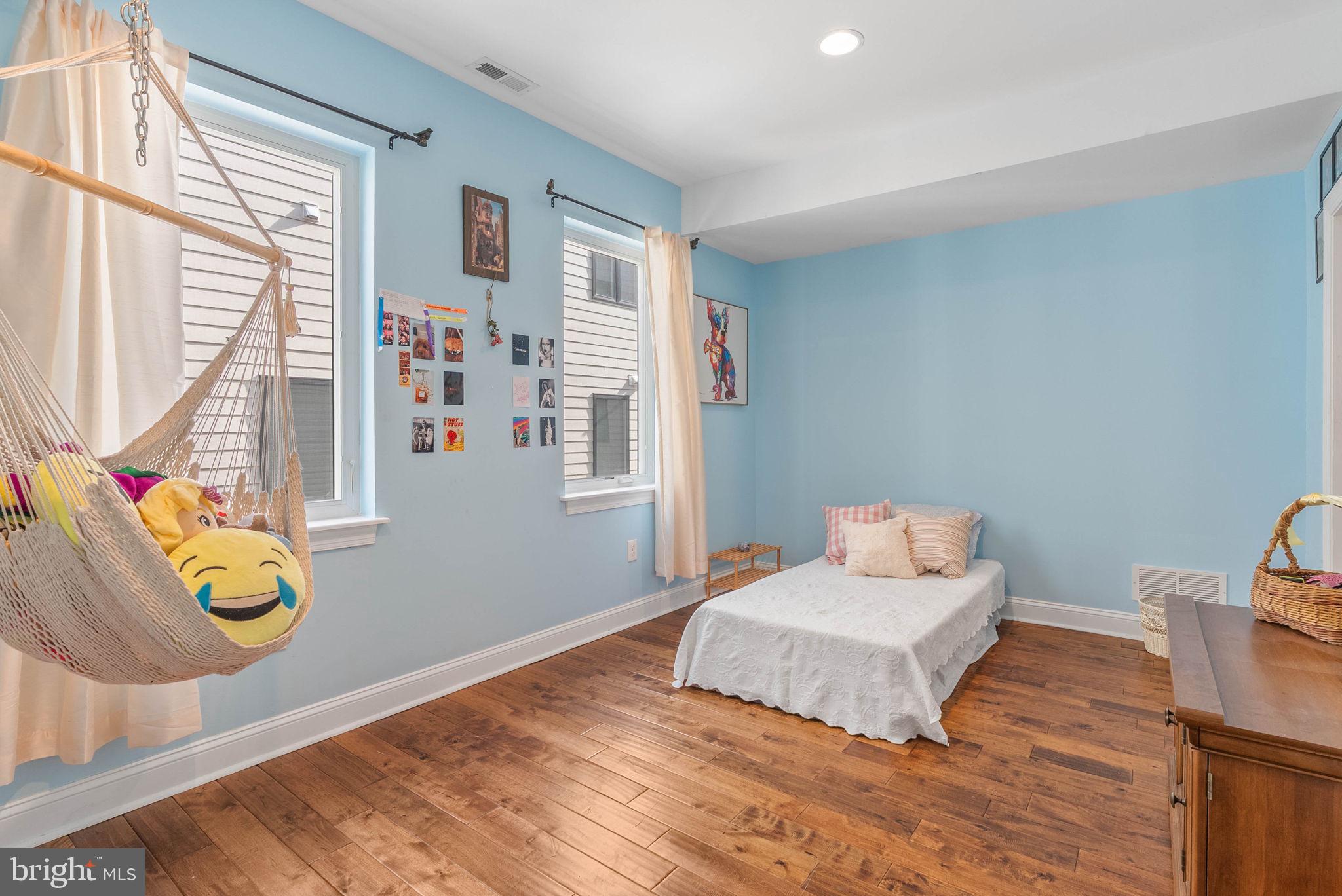 1423 South Howard Street Philadelphia, PA 19147 - Photo 24 of 40 a bedroom with a bed and wooden floor