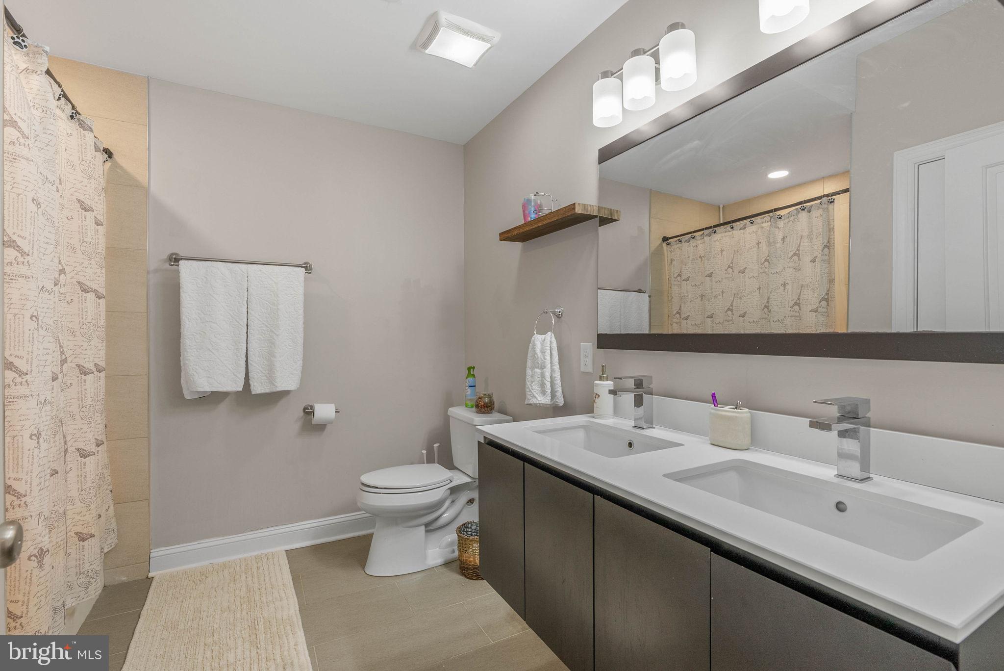 1423 South Howard Street Philadelphia, PA 19147 - Photo 27 of 40 a bathroom with a double vanity sink mirror and toilet