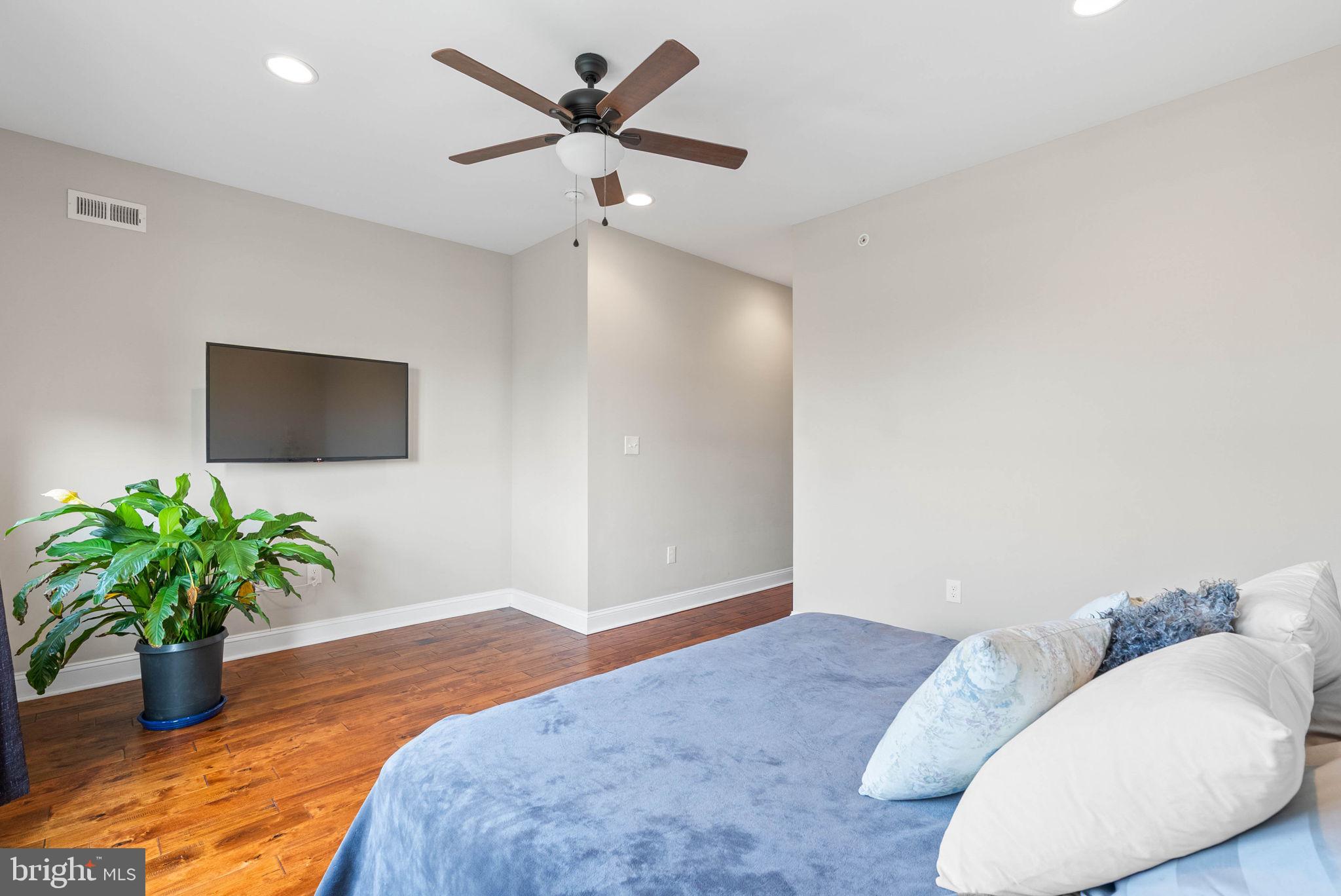 1423 South Howard Street Philadelphia, PA 19147 - Photo 33 of 40 a bedroom with a bed and a potted plant
