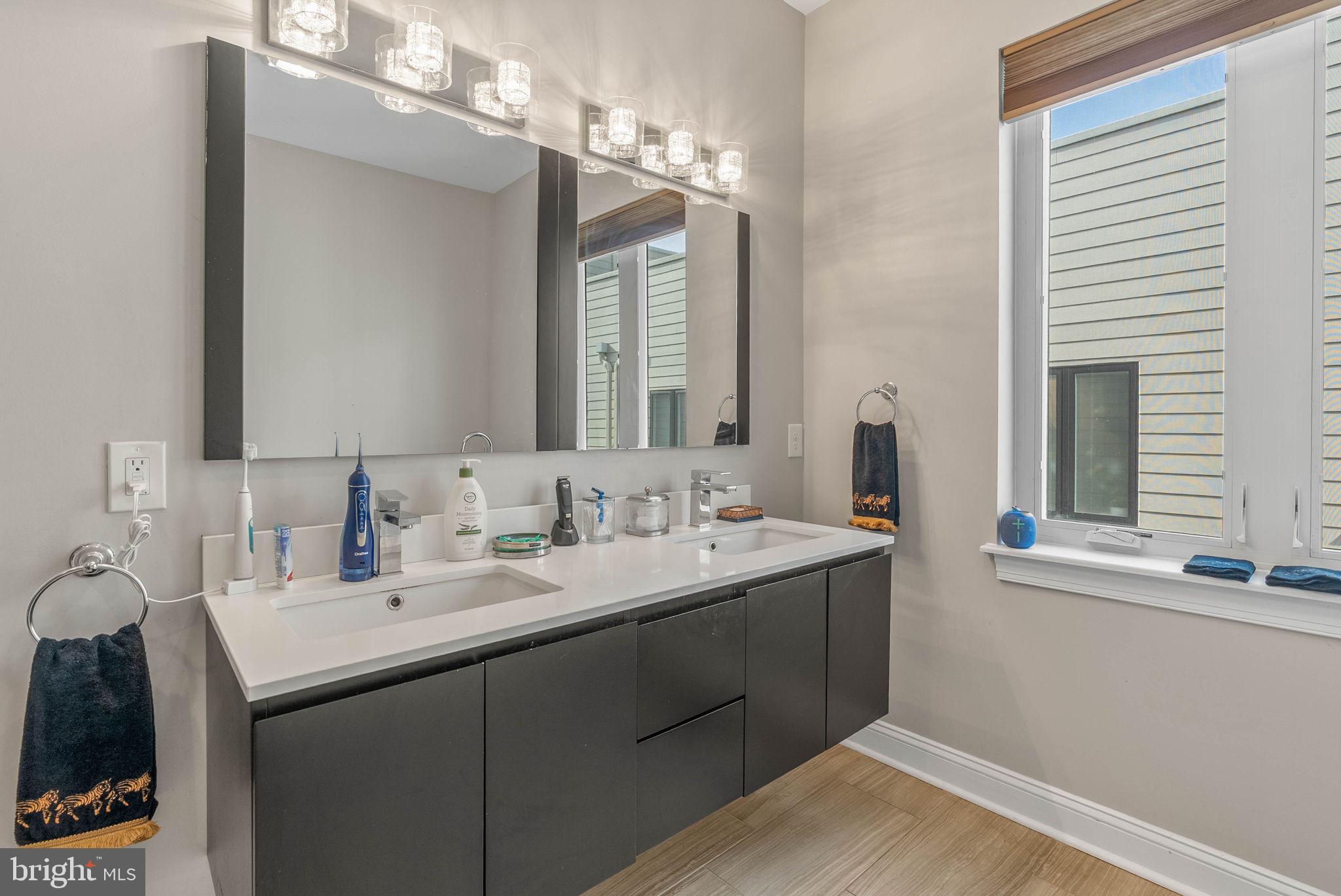 1423 South Howard Street Philadelphia, PA 19147 - Photo 36 of 40 a bathroom with a sink double vanity and a mirror