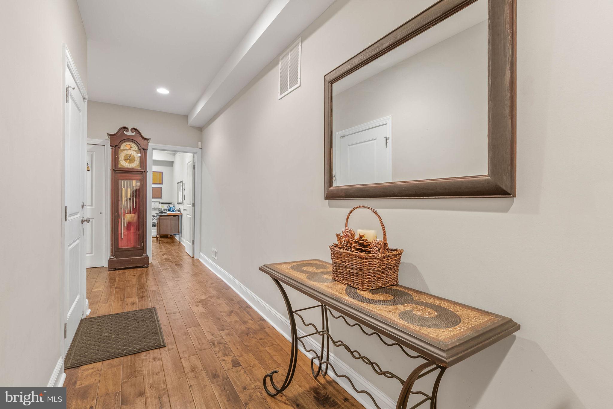 1423 South Howard Street Philadelphia, PA 19147 - Photo 4 of 40 a hallway with a couch a chandelier and a mirror