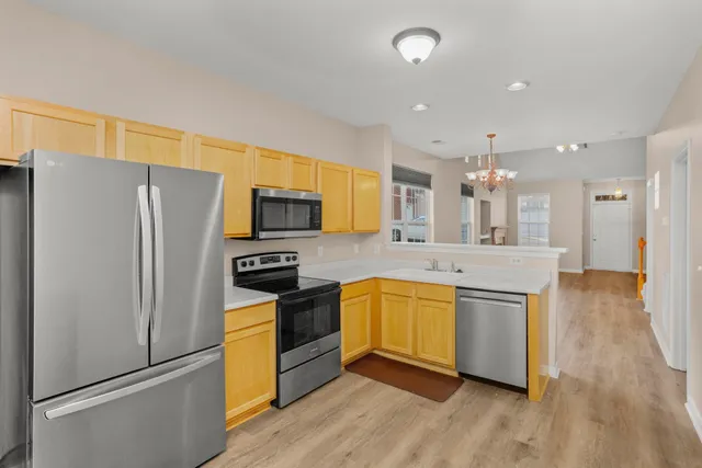 a kitchen with stainless steel appliances a refrigerator and a stove top oven