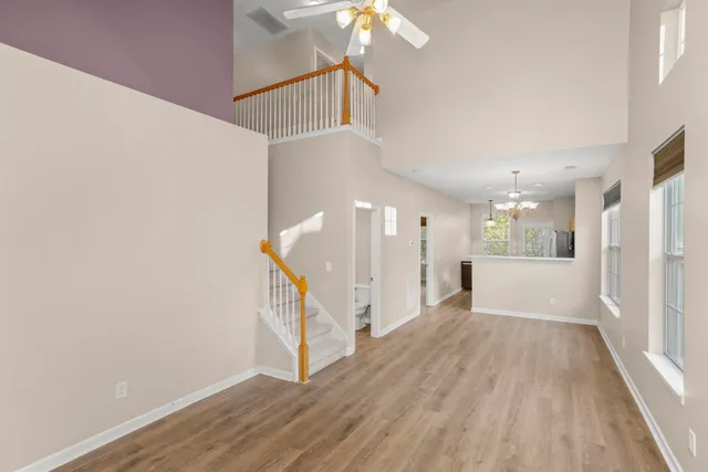 a view of a hallway view with wooden floor and staircase