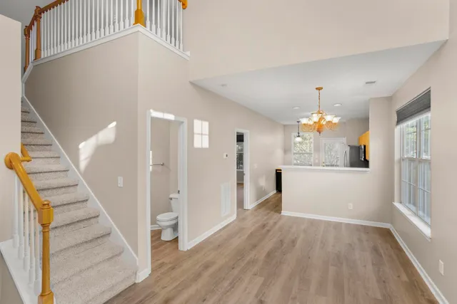 a view of a hallway view with wooden floor and staircase