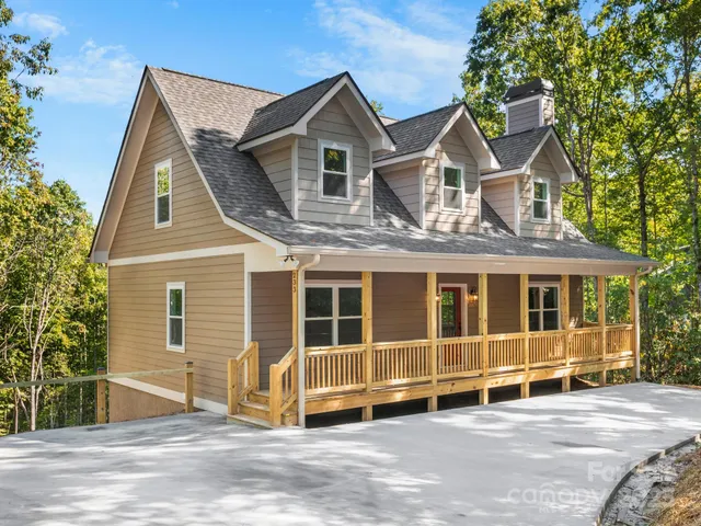 a view of a house with a garage and balcony