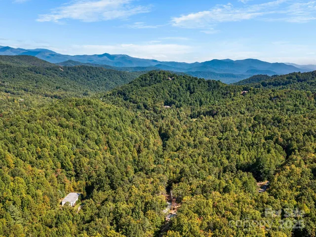 a view of a large building with mountains in the background