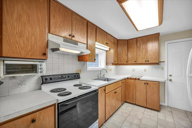 a kitchen with a sink stove and cabinets