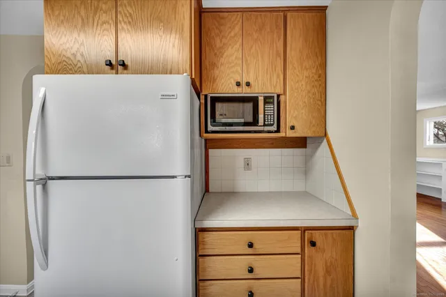 a white refrigerator freezer sitting inside of a kitchen