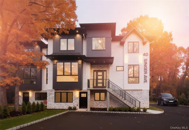 a front view of a residential apartment building with a yard