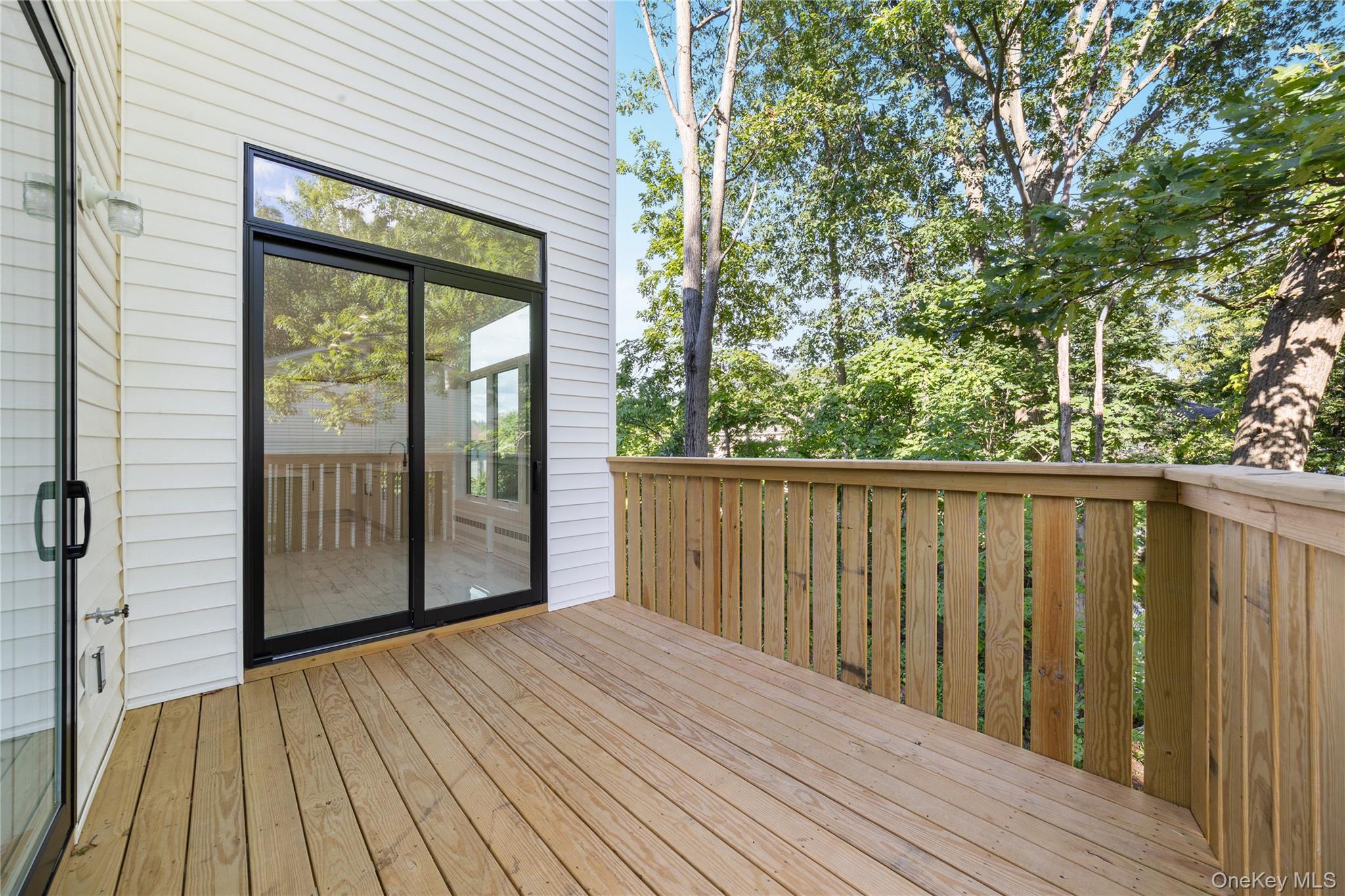 40 Singer Avenue, Unit 214 Spring Valley, NY 10977 - Photo 15 of 49 a view of a wooden balcony with wooden floor