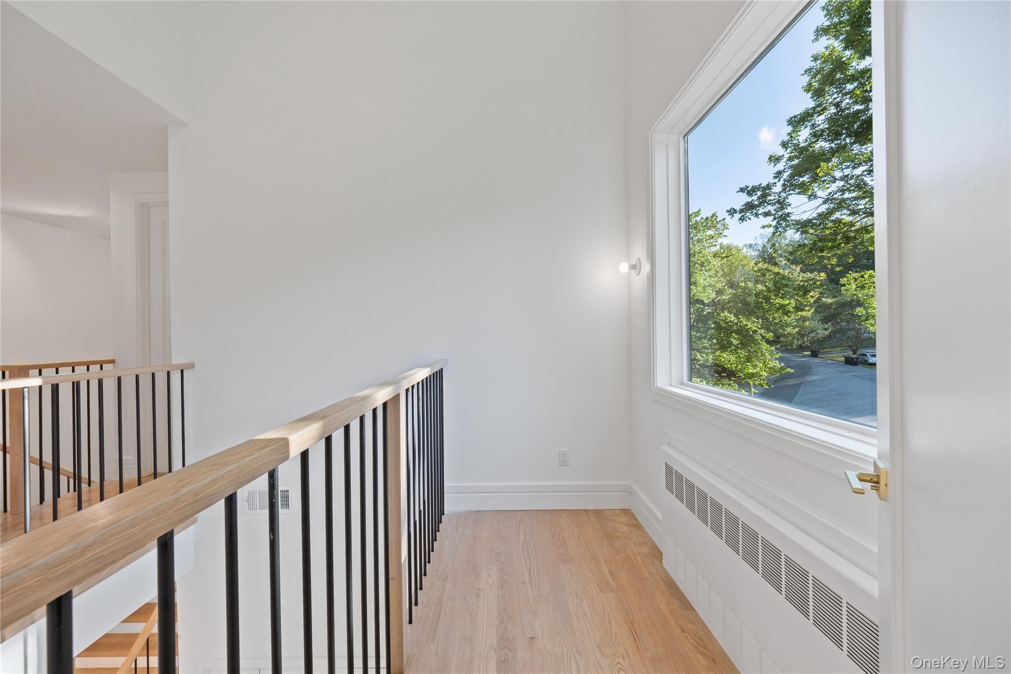 40 Singer Avenue, Unit 214 Spring Valley, NY 10977 - Photo 20 of 49 a view of a hallway with wooden floor and staircase
