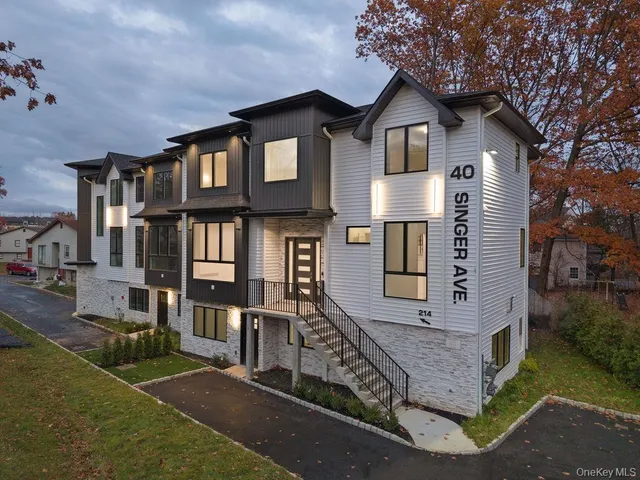 a front view of a house with many windows