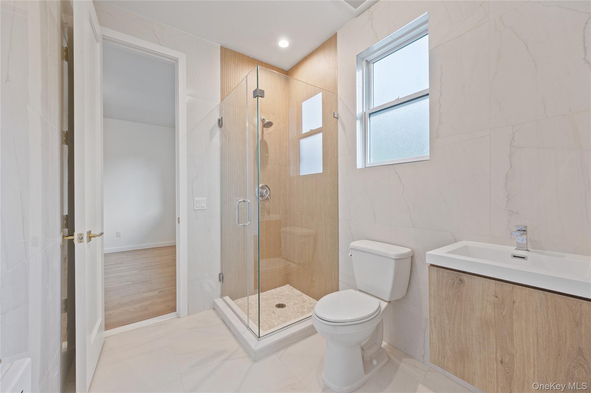 40 Singer Avenue, Unit 214 Spring Valley, NY 10977 - Photo 28 of 49 a bathroom with a toilet a sink and shower