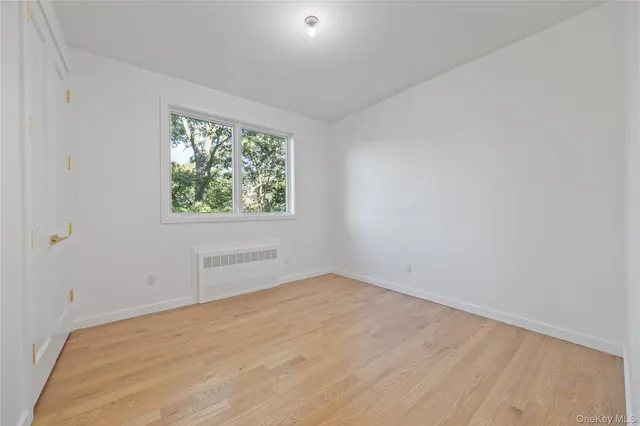 a view of a hallway with wooden floor and glass door
