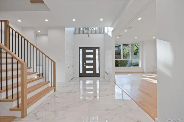 a view of an entryway with wooden floor and windows