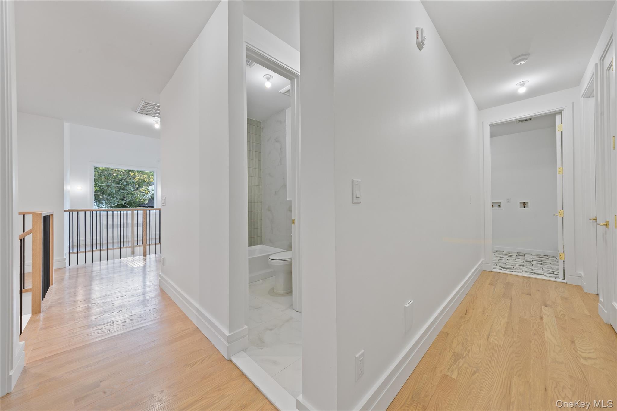 40 Singer Avenue, Unit 214 Spring Valley, NY 10977 - Photo 32 of 49 a view of a hallway with wooden floor and glass door