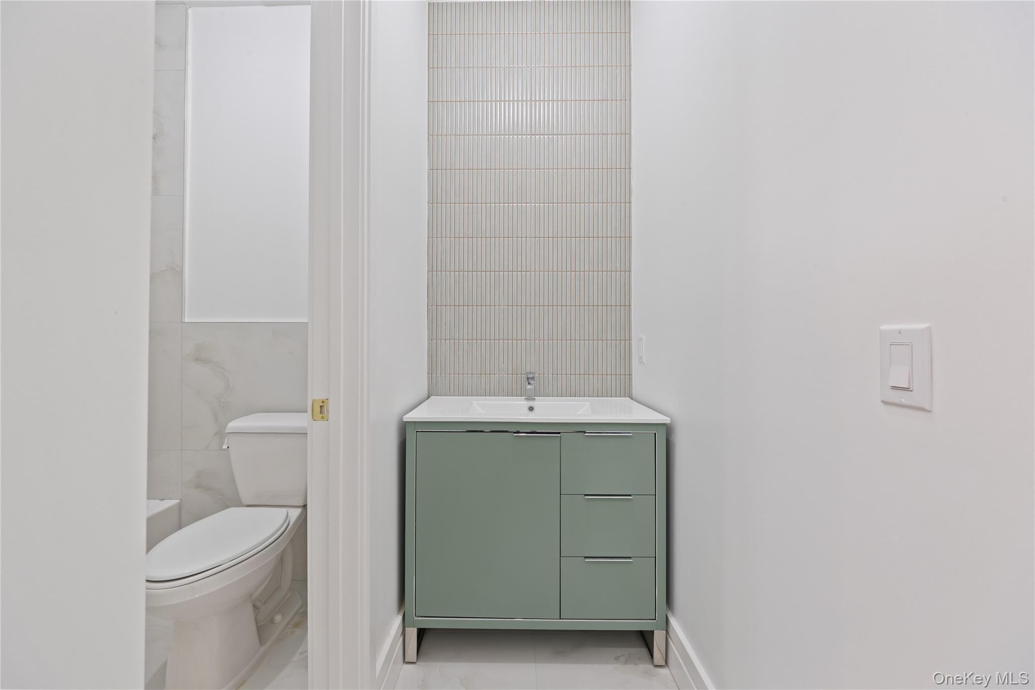 40 Singer Avenue, Unit 214 Spring Valley, NY 10977 - Photo 33 of 49 a bathroom with a toilet sink and mirror