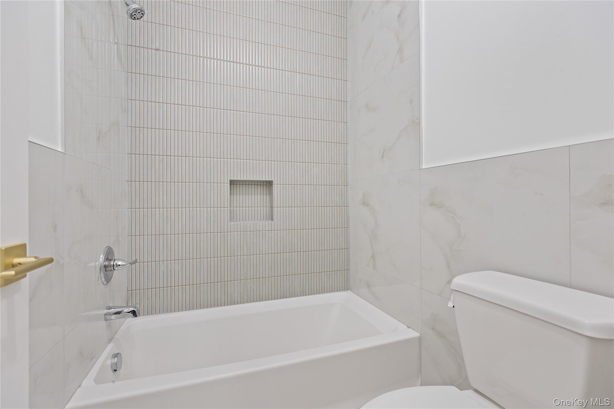 40 Singer Avenue, Unit 214 Spring Valley, NY 10977 - Photo 34 of 49 a bath tub sitting next to a white toilet and a shower