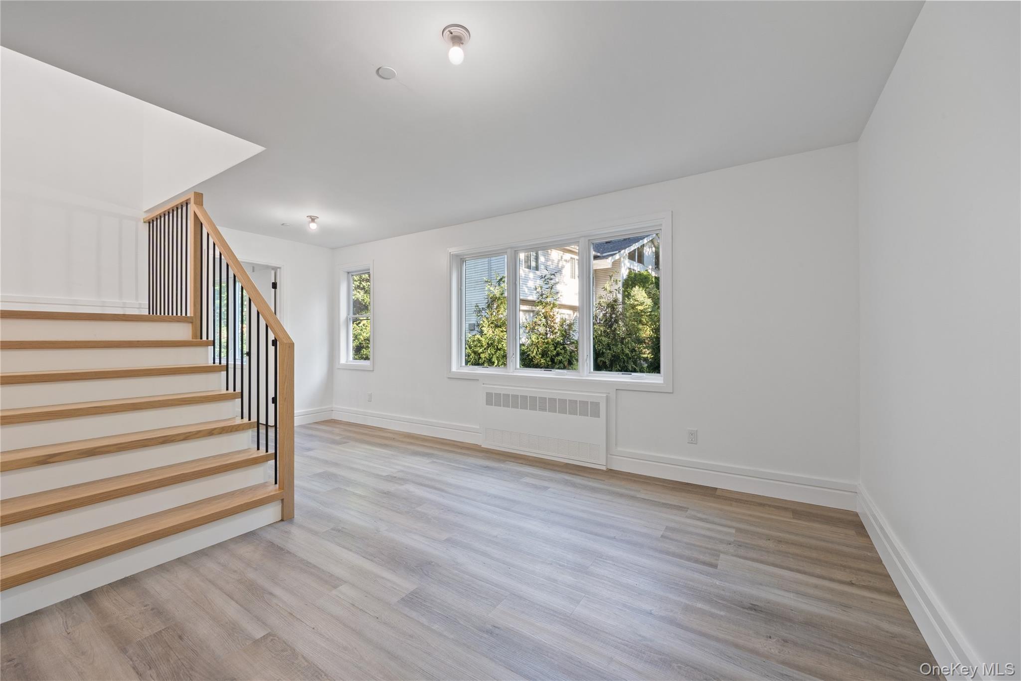 40 Singer Avenue, Unit 214 Spring Valley, NY 10977 - Photo 37 of 49 wooden floor in an empty room with a window