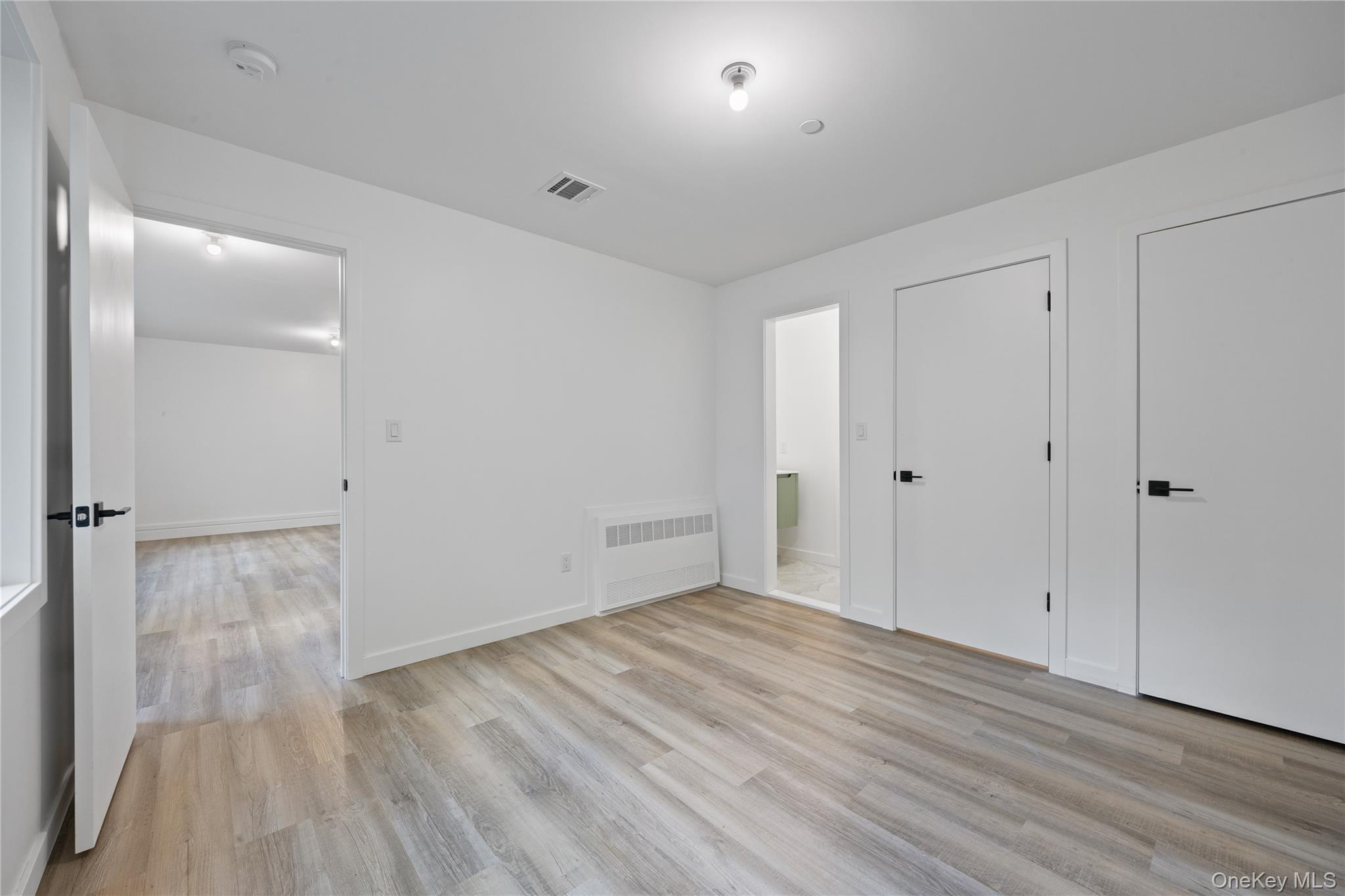 40 Singer Avenue, Unit 214 Spring Valley, NY 10977 - Photo 45 of 49 a view of an empty room with wooden floor