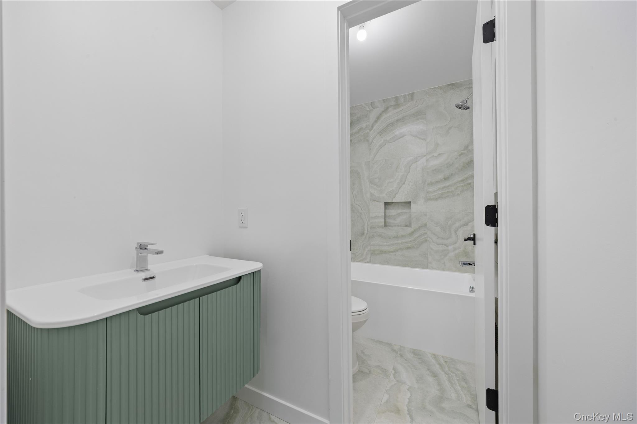 40 Singer Avenue, Unit 214 Spring Valley, NY 10977 - Photo 46 of 49 a bathroom with a sink a toilet and shower