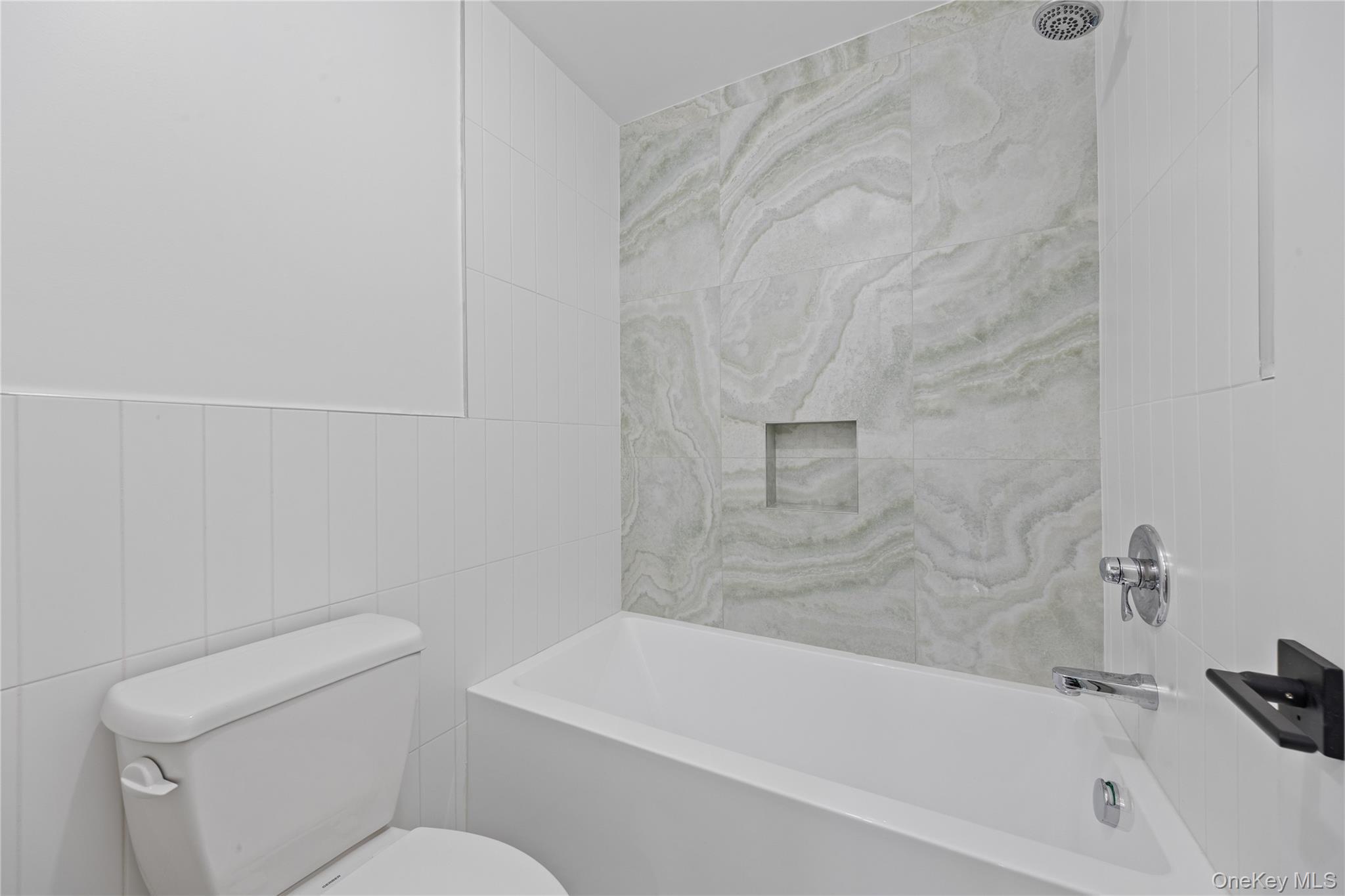 40 Singer Avenue, Unit 214 Spring Valley, NY 10977 - Photo 47 of 49 a bathroom with a toilet and bathtub