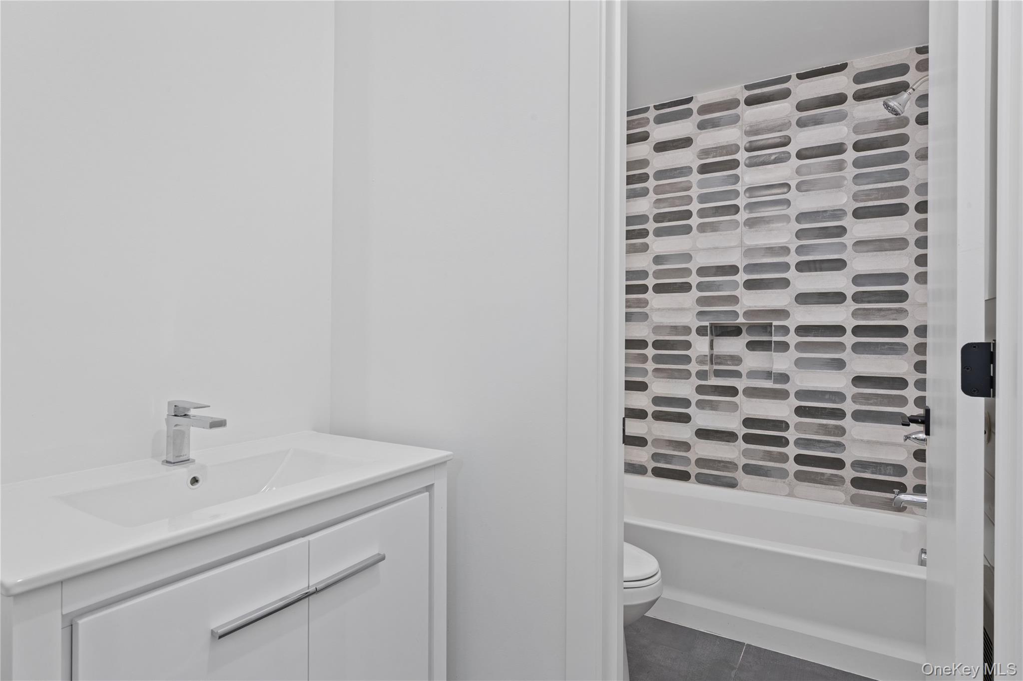 40 Singer Avenue, Unit 214 Spring Valley, NY 10977 - Photo 49 of 49 a bathroom with a sink and a mirror