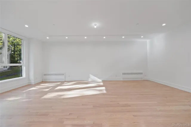 a large white kitchen with kitchen island a sink a stove and a refrigerator