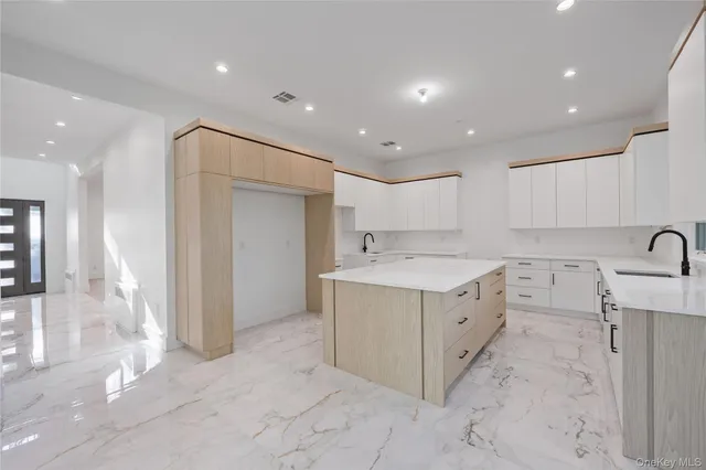 a view of a kitchen with a sink and a large window