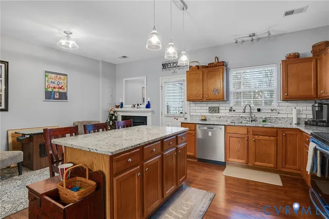 a kitchen with a sink stove and wooden cabinets