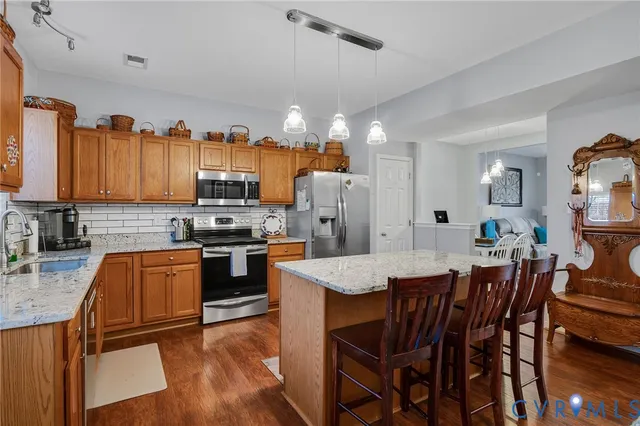 a large kitchen with a table and chairs