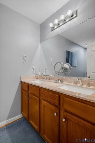 a bathroom with a double vanity sink and a mirror
