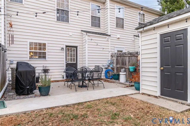 a view of a dinning tables and chairs in backyard of the house