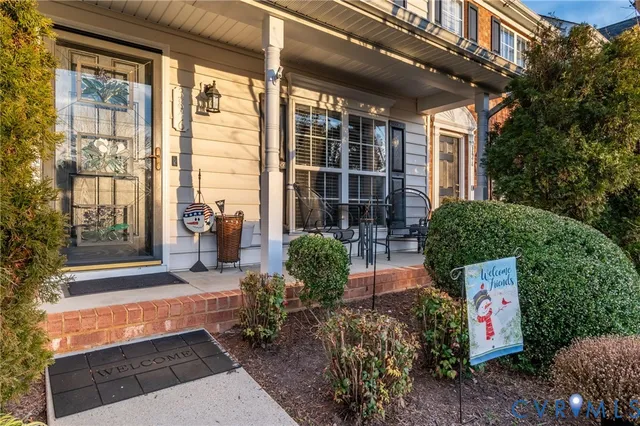 a house with potted plants in front of it
