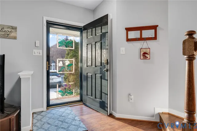 a view of an entryway with wooden floor
