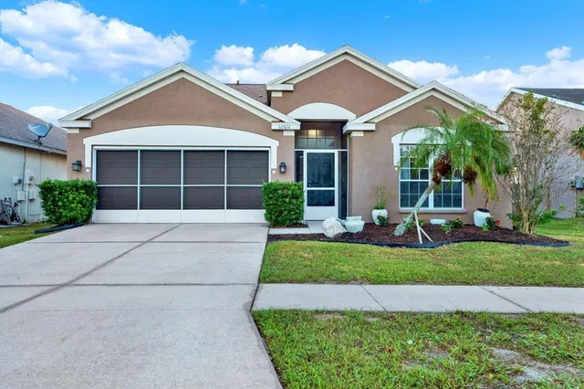 a front view of a house with a yard and garage