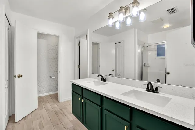 a bathroom with a sink double vanity and a mirror