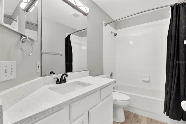 a bathroom with a sink toilet tub and shower