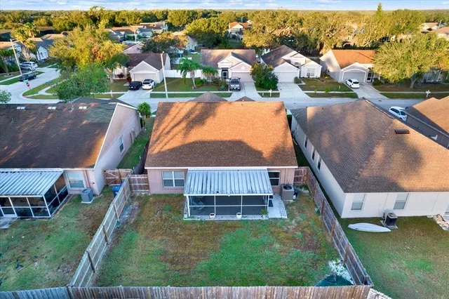 an aerial view of residential houses with outdoor space and swimming pool