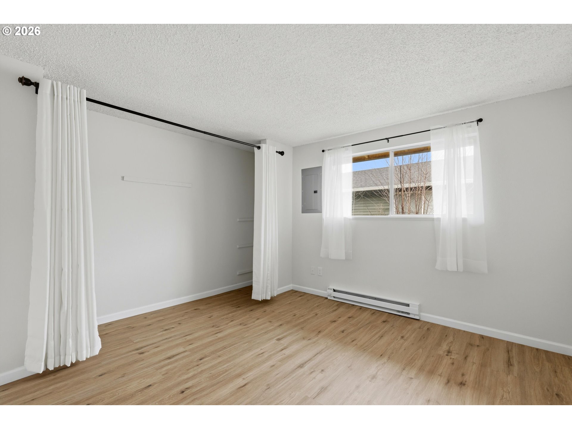 1267 Northeast 183rd Avenue Portland, OR 97230 - Photo 13 of 34 a view of an empty room with wooden floor and a window