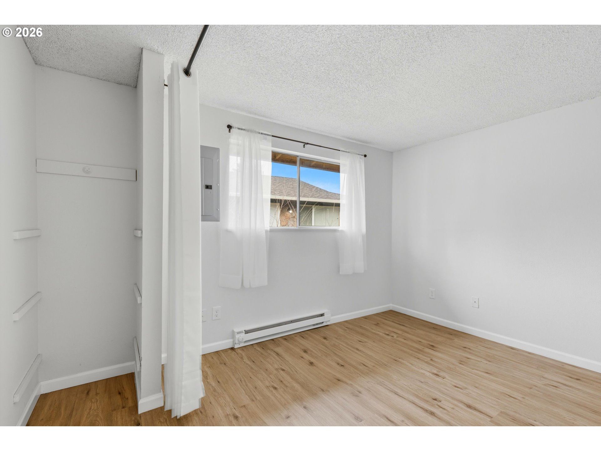 1267 Northeast 183rd Avenue Portland, OR 97230 - Photo 14 of 34 a view of an empty room with wooden floor and a window