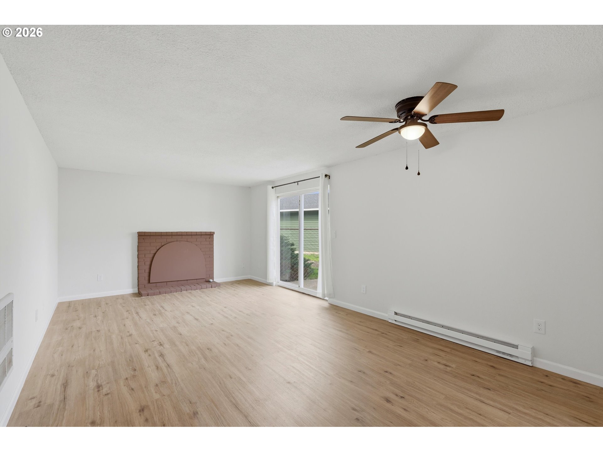1267 Northeast 183rd Avenue Portland, OR 97230 - Photo 3 of 34 a view of room with hardwood floor and a ceiling fan