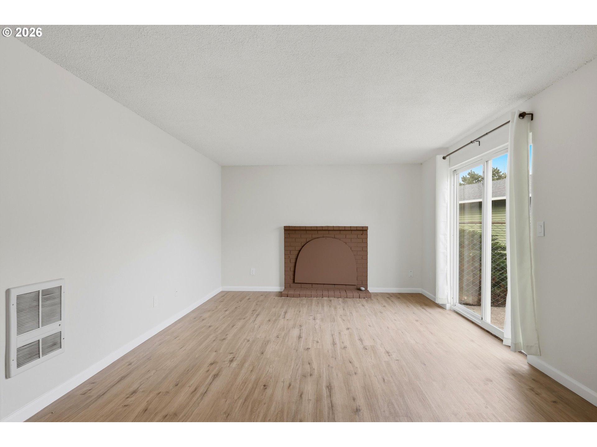 1267 Northeast 183rd Avenue Portland, OR 97230 - Photo 4 of 34 a view of an empty room with wooden floor and a window