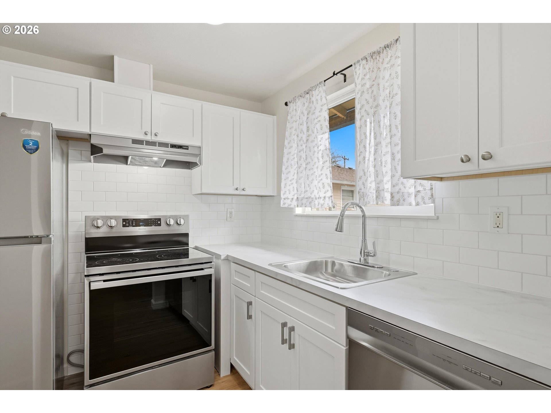 1267 Northeast 183rd Avenue Portland, OR 97230 - Photo 9 of 34 a kitchen with cabinets appliances and a sink